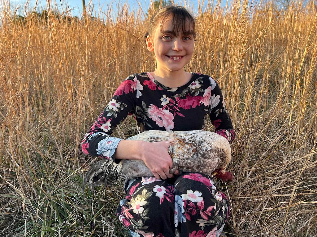 12 year old holding dead rooster