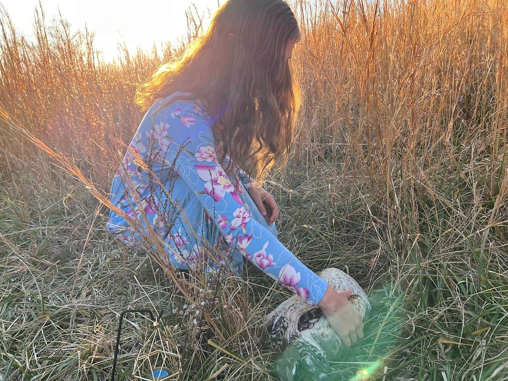 girl saying goodbye to dead rooster