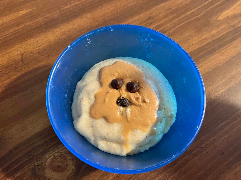 bowl of cream of wheat with a peanut butter groundhog in it