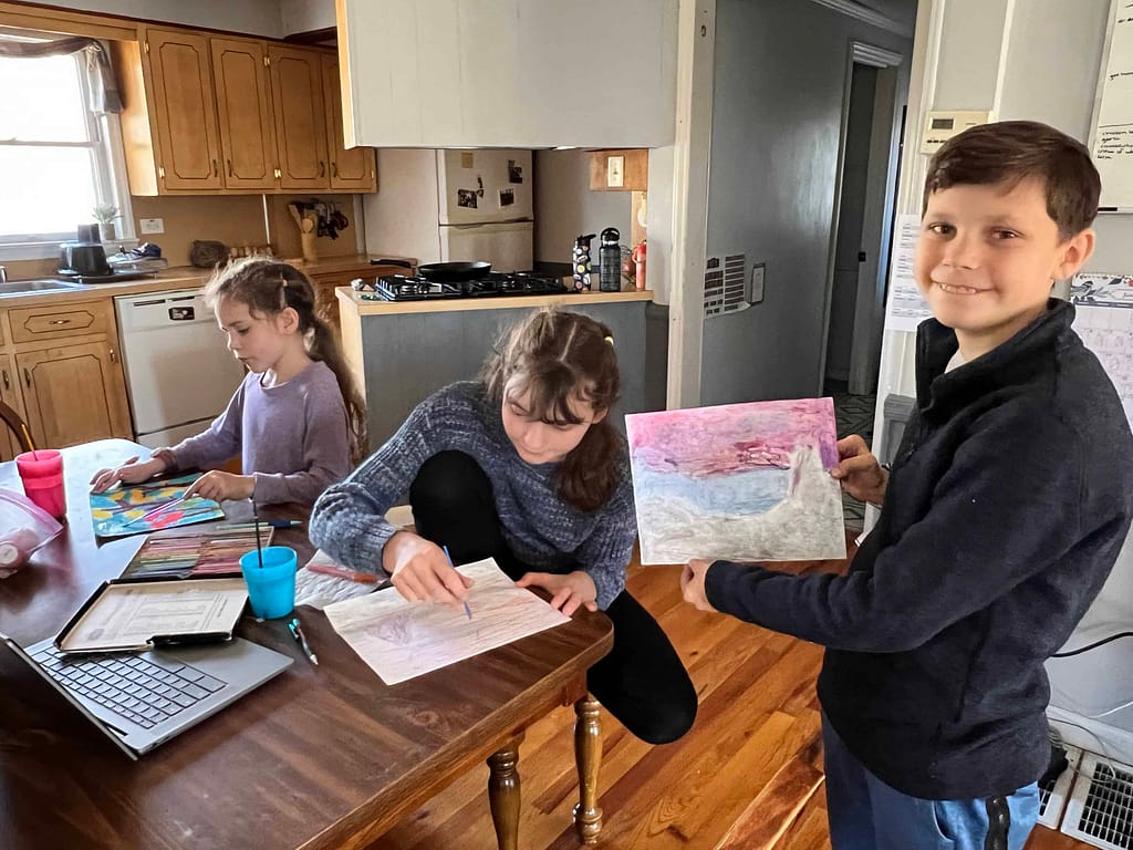 children showing pictures of painting shiprock, NM