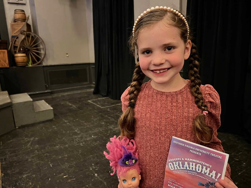girl holding Oklahoma program.