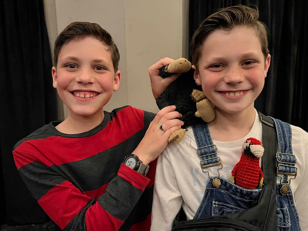two boys playing with stuffed animals