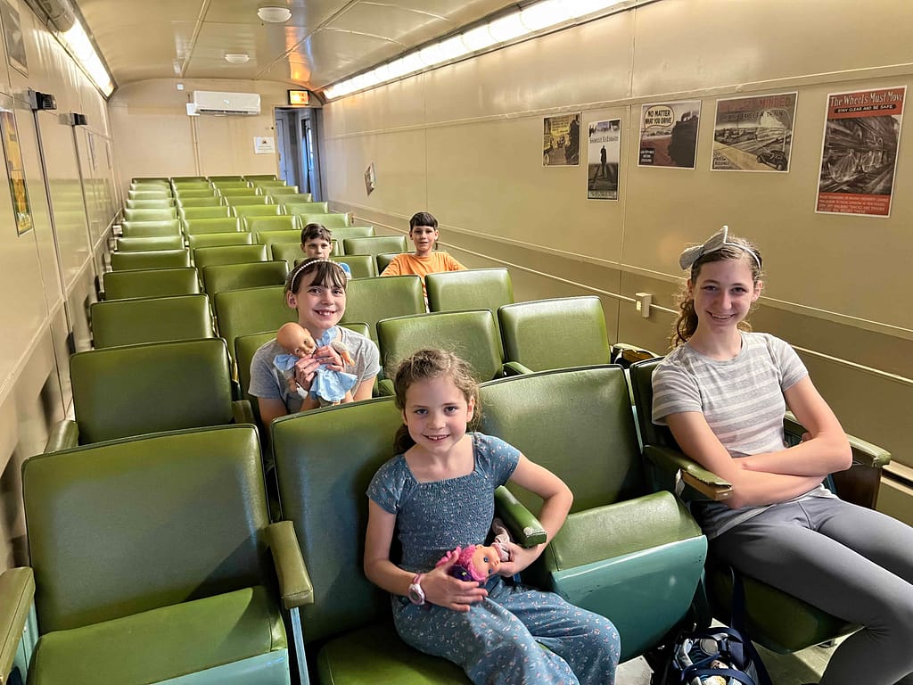 5 kids on an old train in a museum