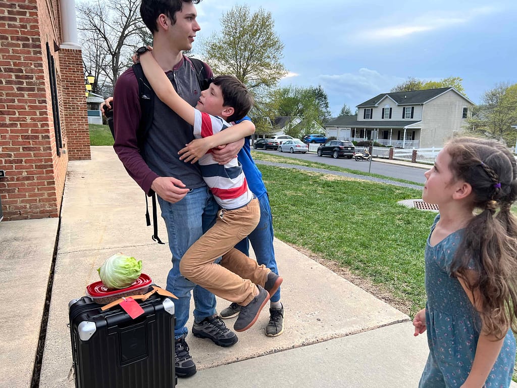 little brother jumps on bigger brother before he goes into the dorms