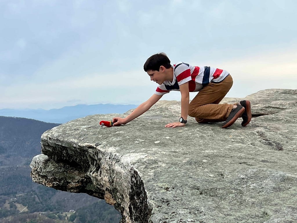 boy with stuffed parrot on McAffee Knob, VA