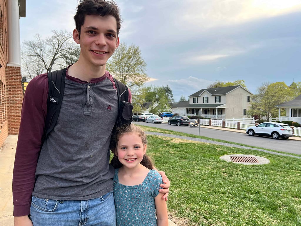 college brother hugs little sister