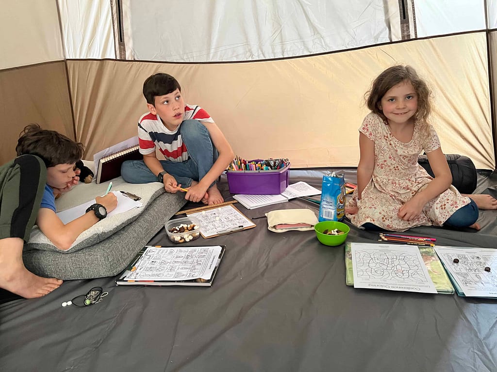 3 kids in a tent drawing