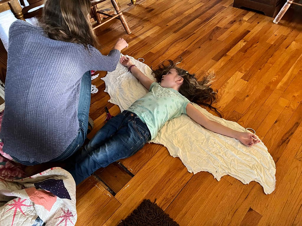 girl making dragon wings for a dragon costume