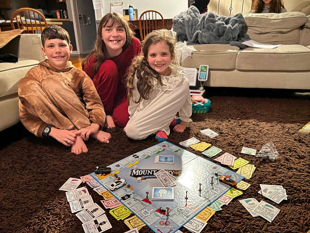 3 siblings playing Mt. Airy Monopoly
