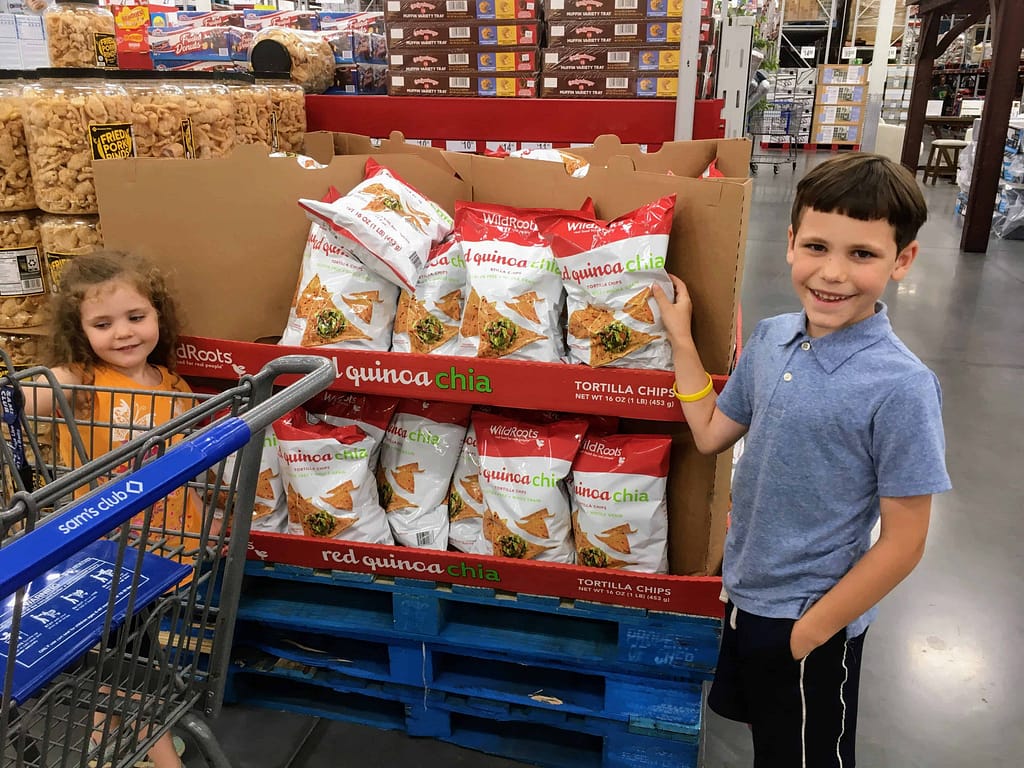 boy and girl pick out quinoa chips at Sam's Club