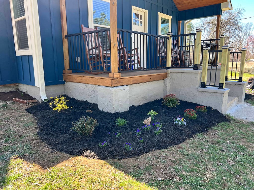 newly planted flowers in front of a house
