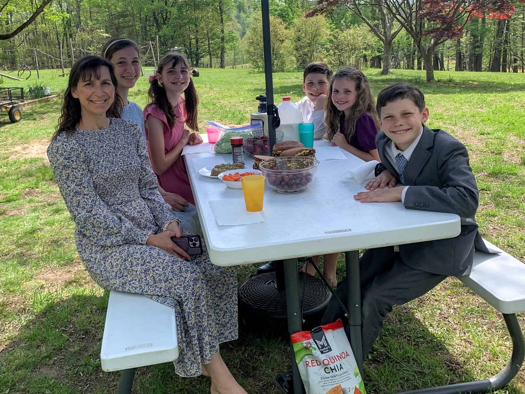 family eating egg sandwiches outside