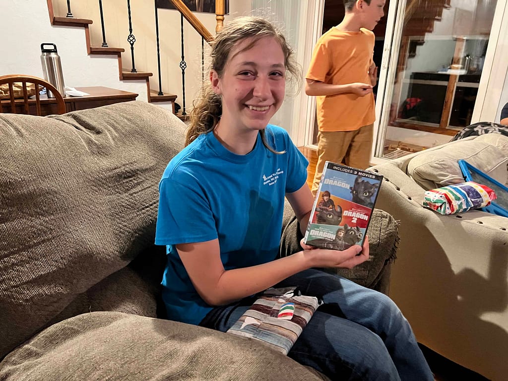 girl opening a dragon DVD