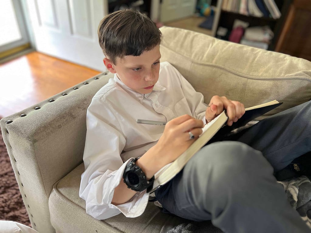 boy writing in his journal