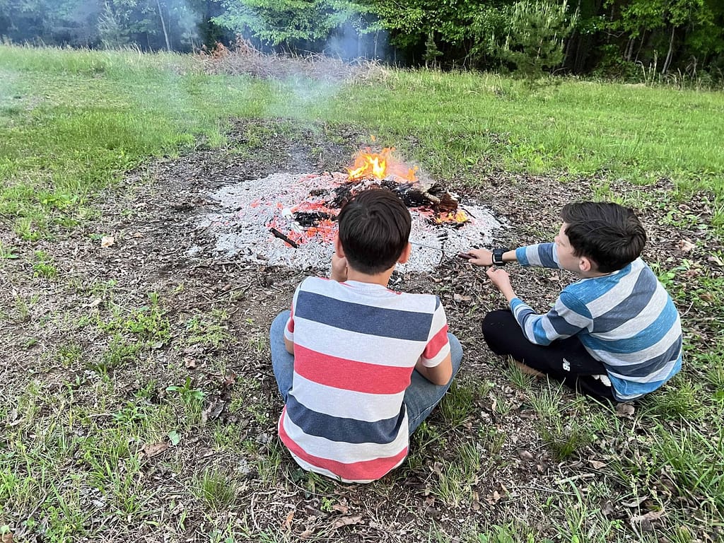 2 boys roasting marshmallows