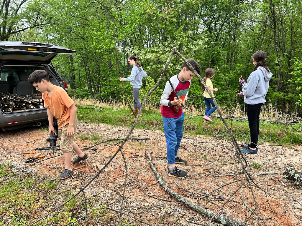 kids cutting up a tree