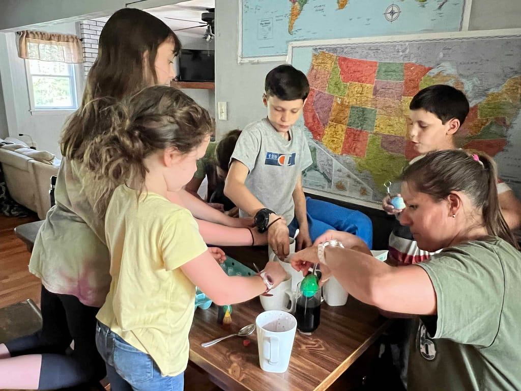 kids dyeing Easter eggs