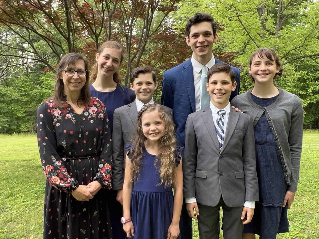 mom and 6 siblings wearing blue and gray