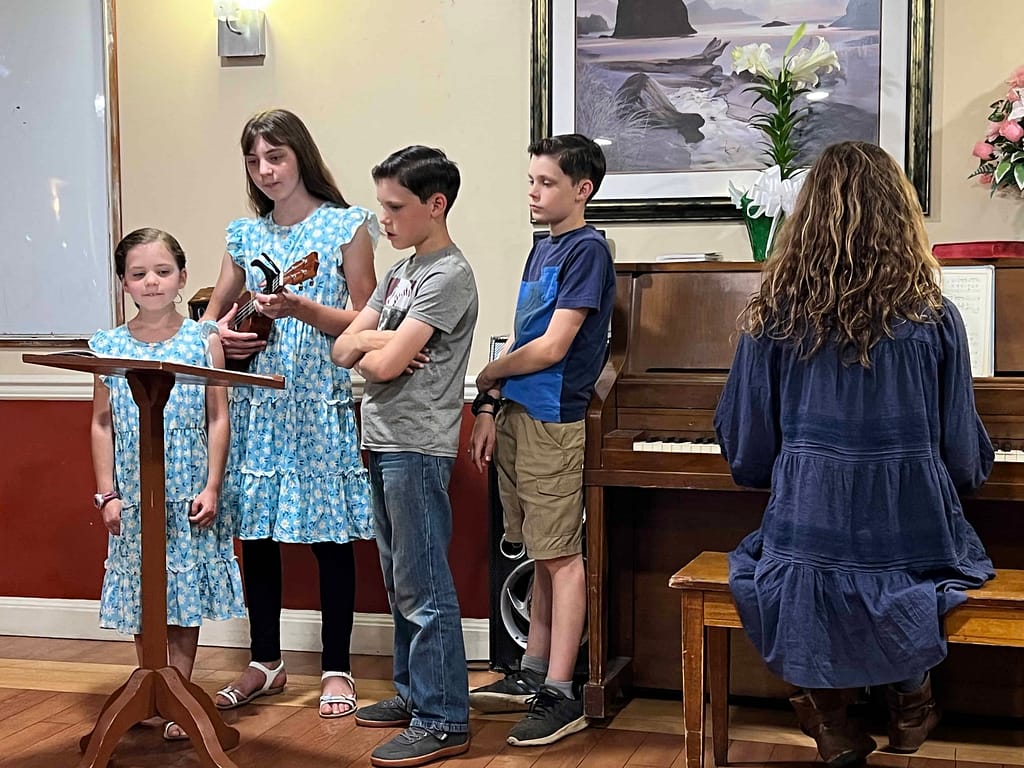 5 kids singing at a nursing home