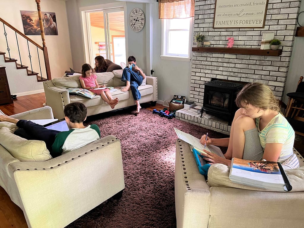 kids sitting on couches doing schoolwork