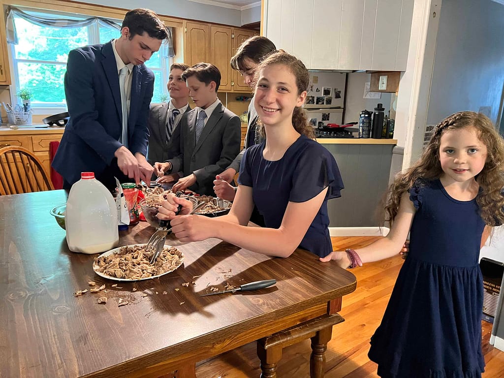 kids shredding pork with forks