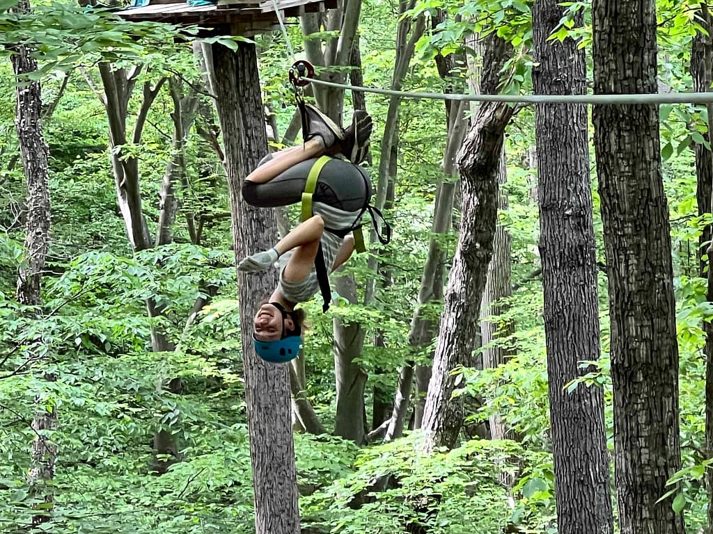 15 year old girl hanging upside down ziplining