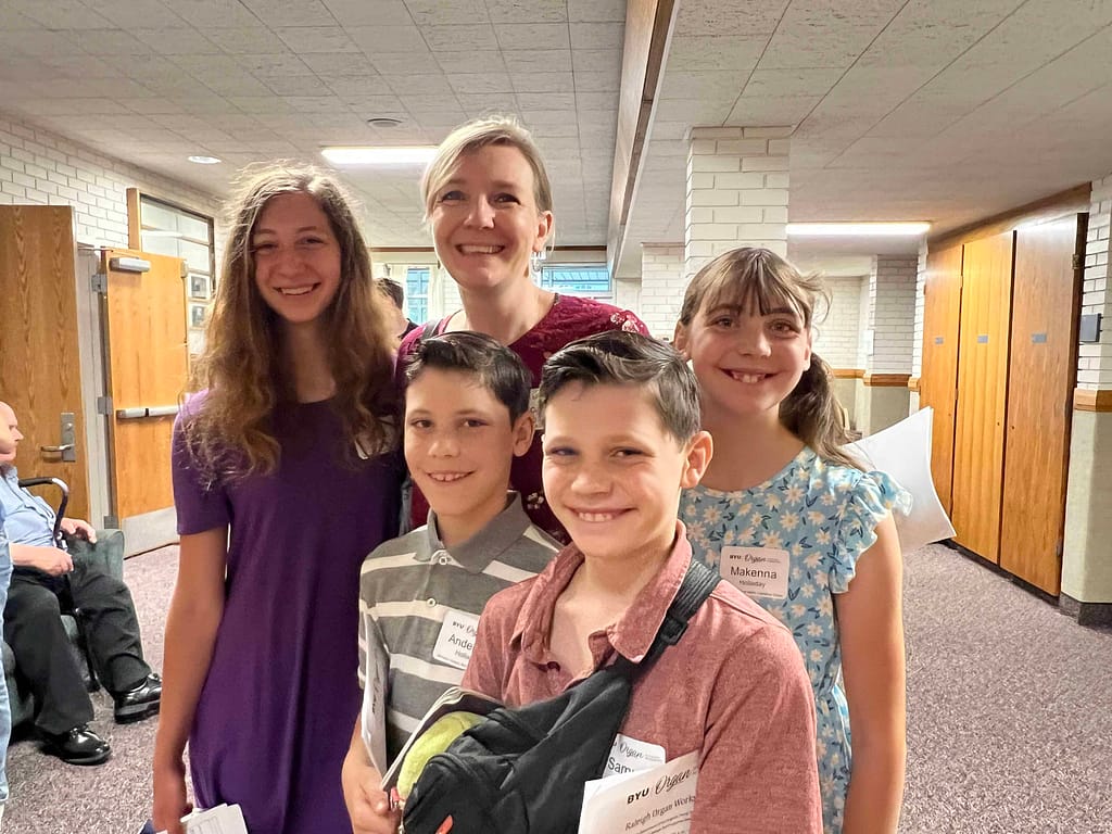 4 kids at an organ workshop