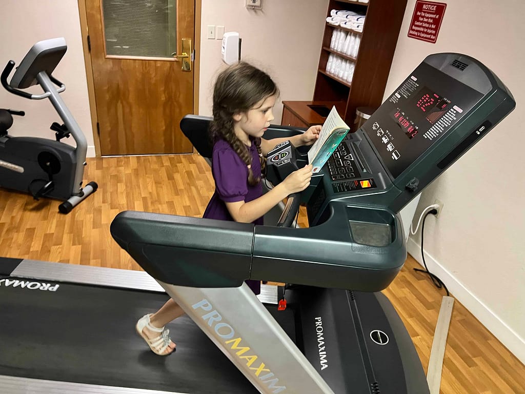 7 year old walking on treadmill and reading
