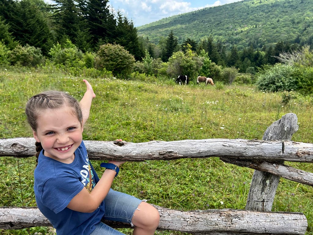 8 year old girl with wild ponies at Grayson State Park