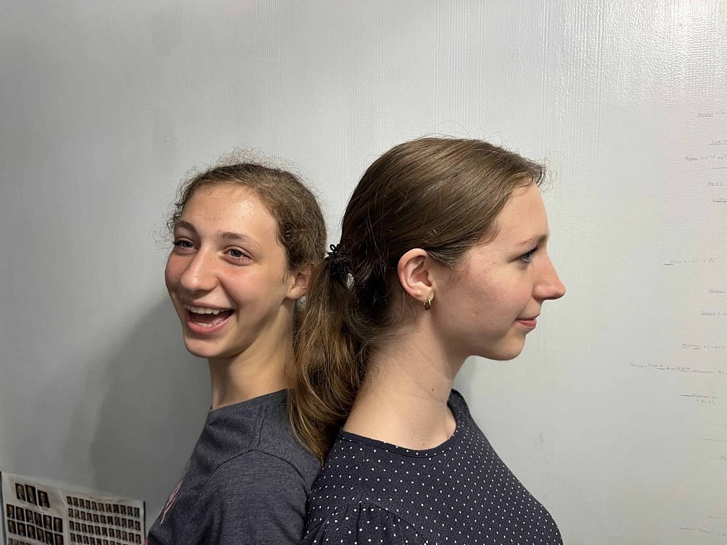 sisters measure to see who is taller