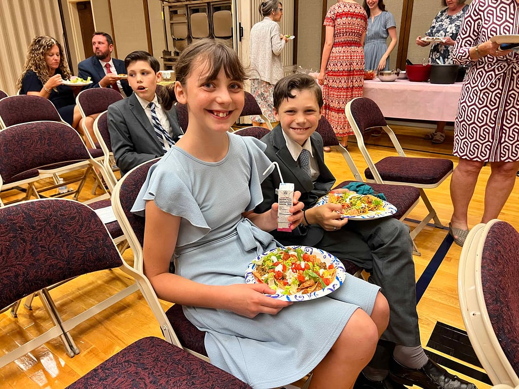 brother and sister at church social