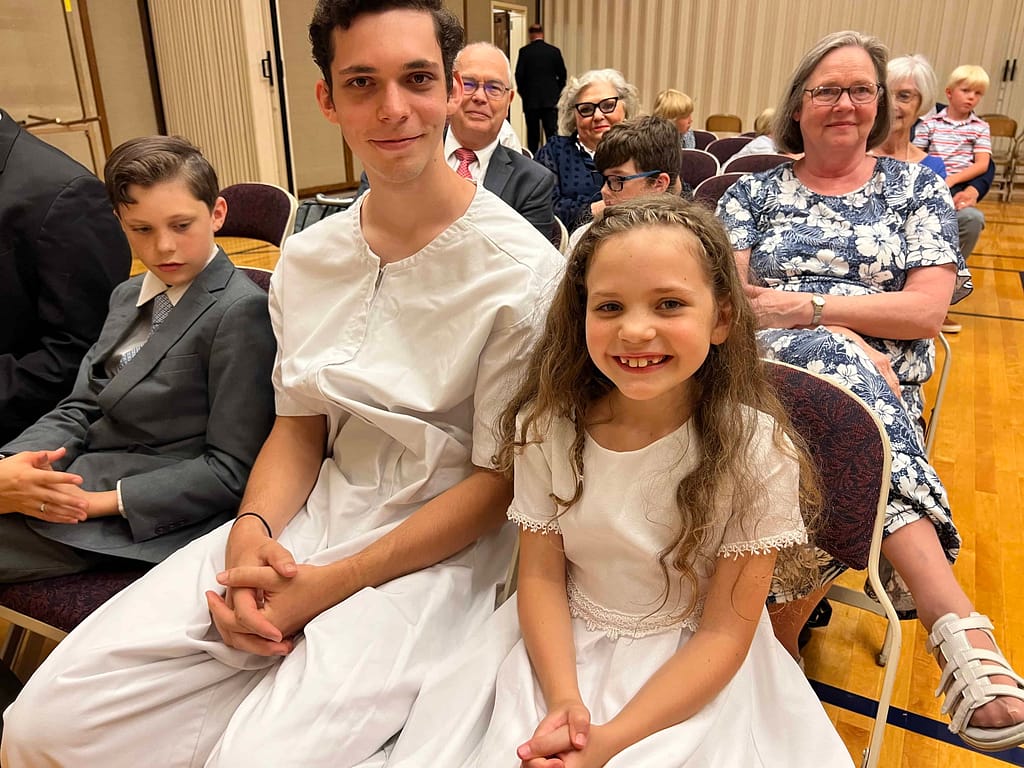 brother and sister waiting for their baptism