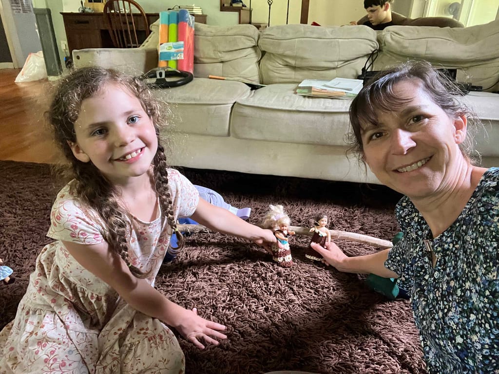 mom and daughter playing American Girl mini dolls