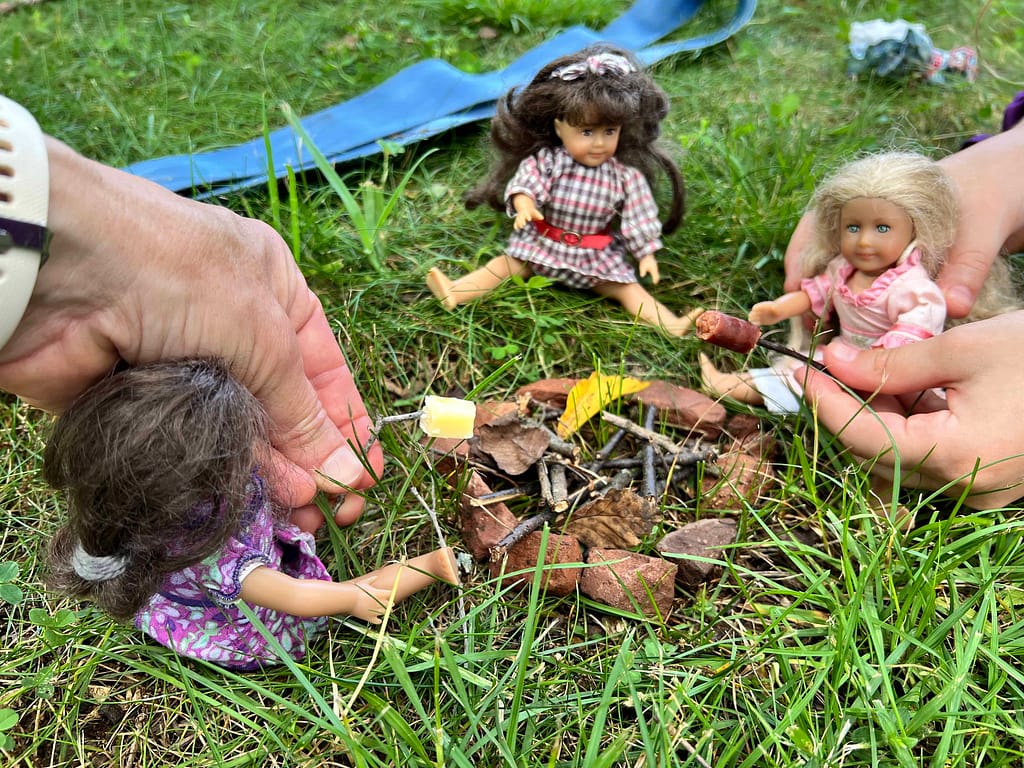 American Girl mini dolls having a campfire