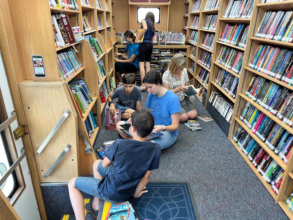family reading in bookmobile