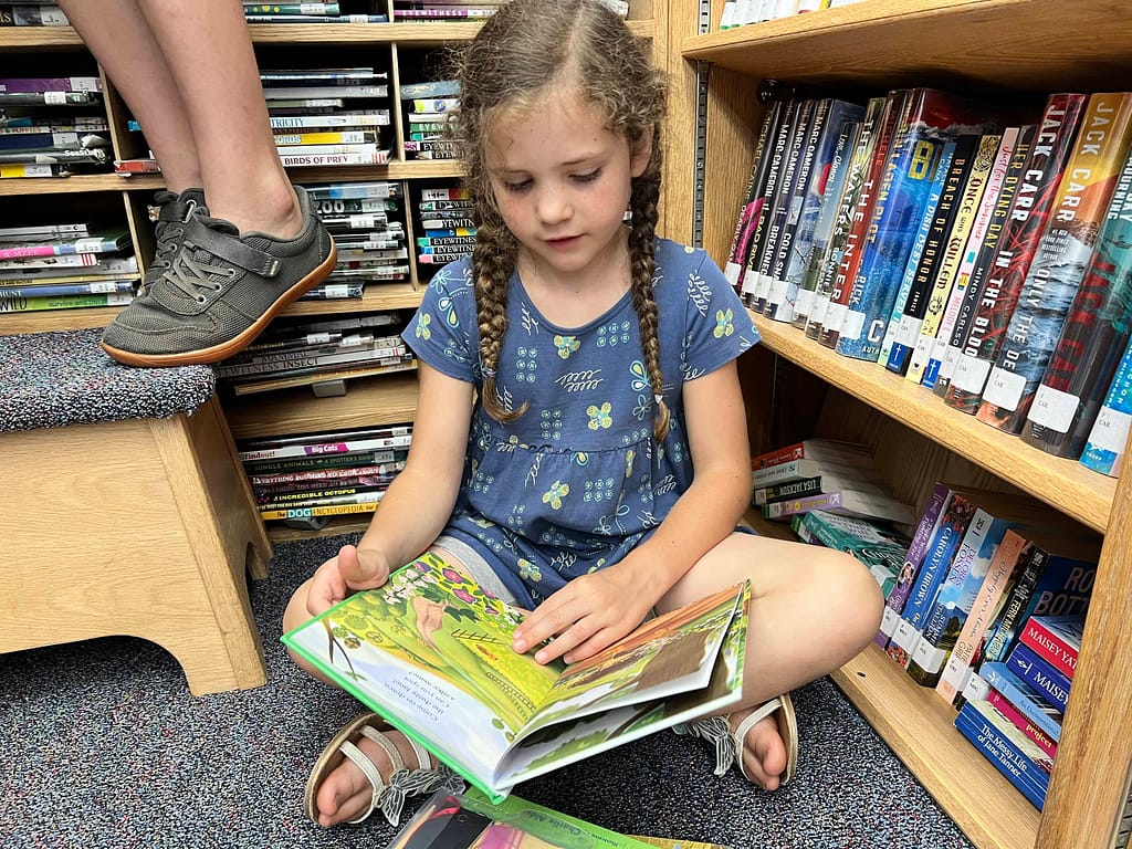 8 year old reading in bookmobile
