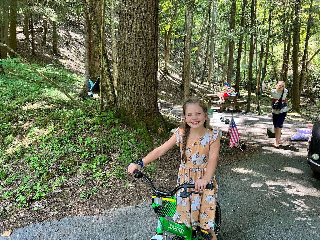 7 year old girl riding her bike at a campground