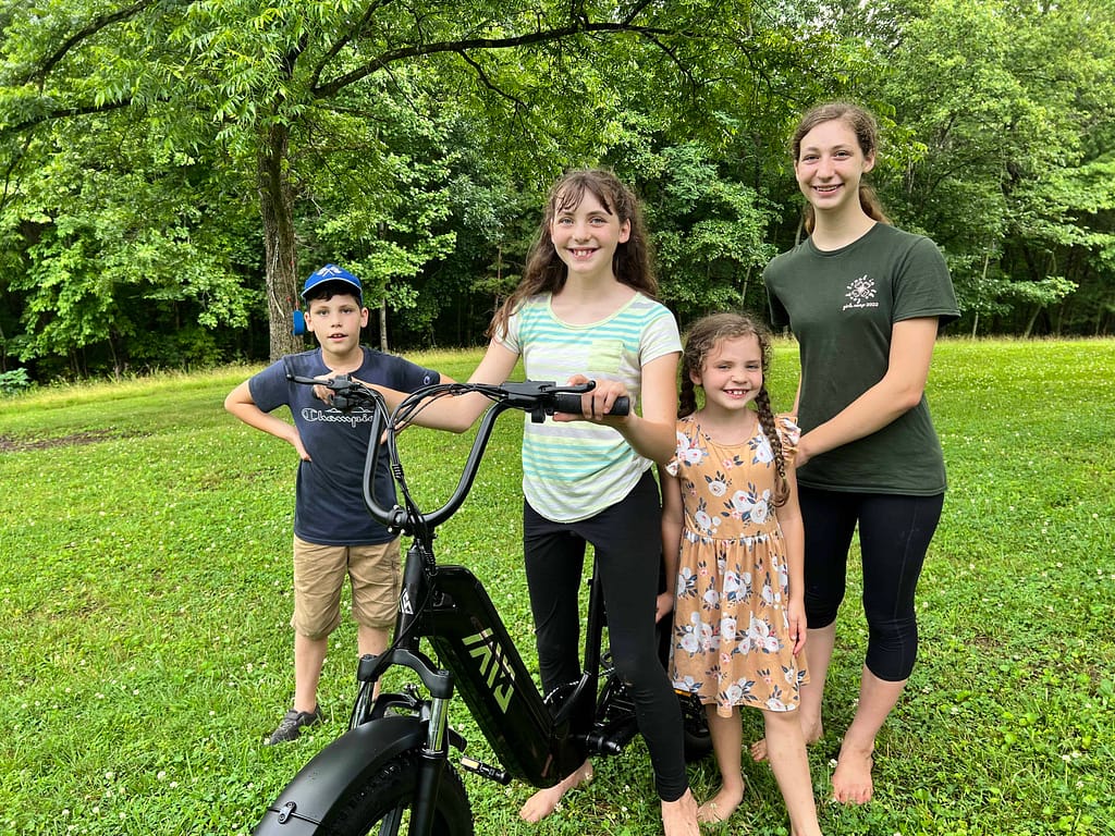 four kids with TST e-bike