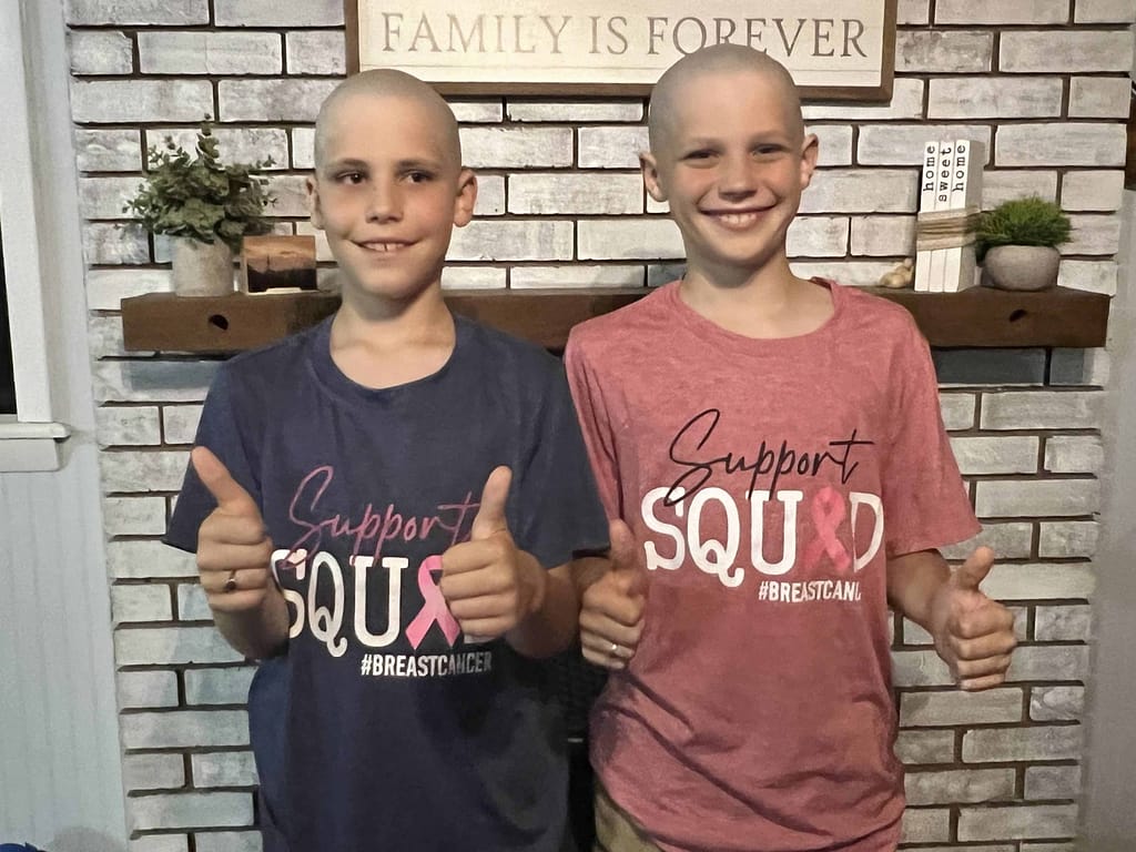 two boys shaved bald in support of breast cancer
