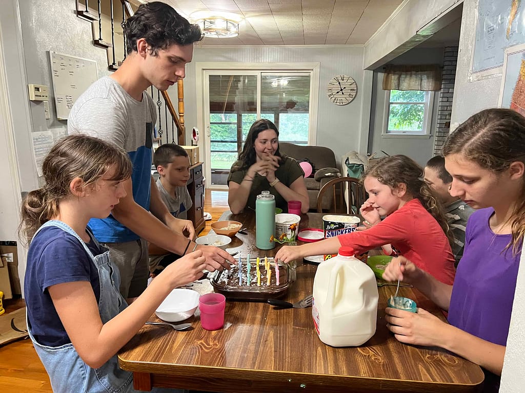 kids cutting brownies for a birthday cake
