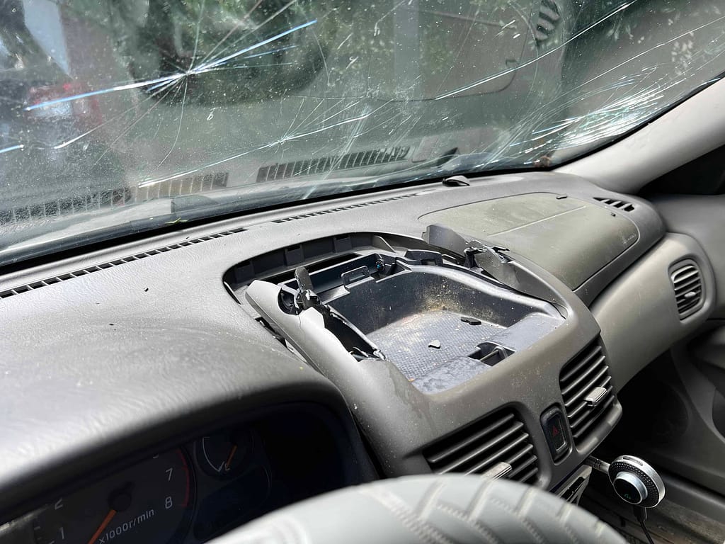 broken car compartment and windshield