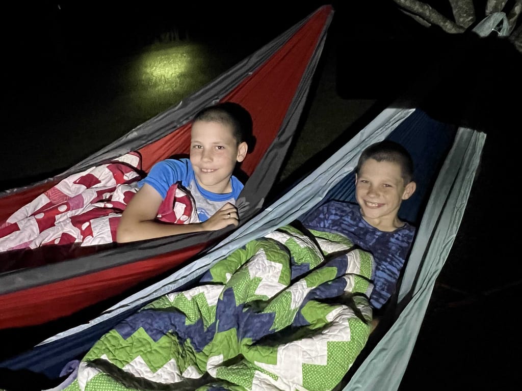 two brothers sleeping in hammocks