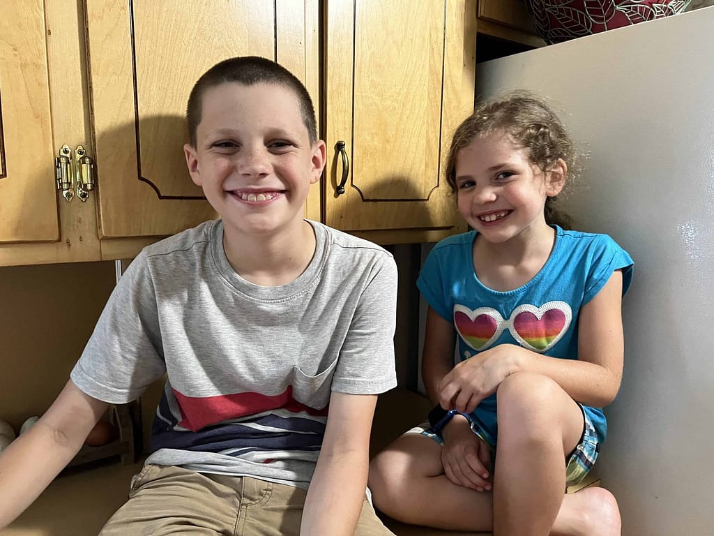 boy and girl sitting on counter