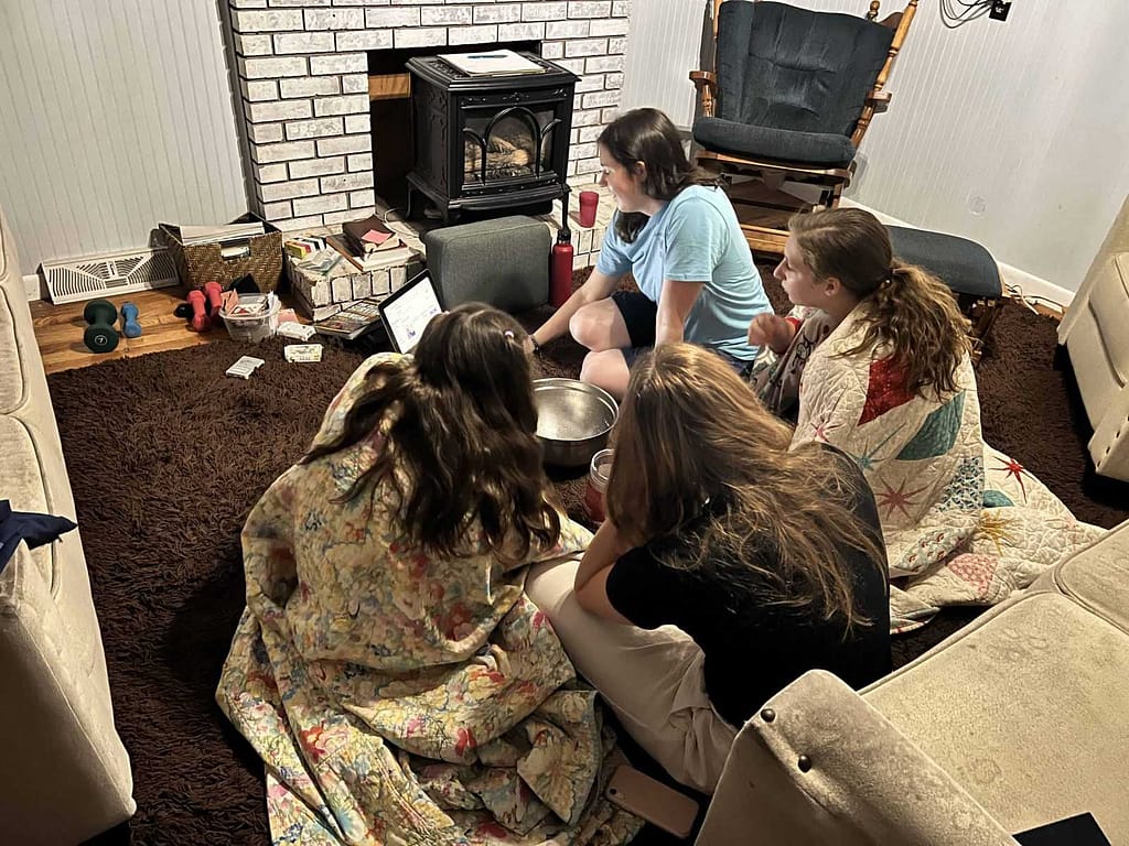 4 sisters eating popcorn on the living room floor