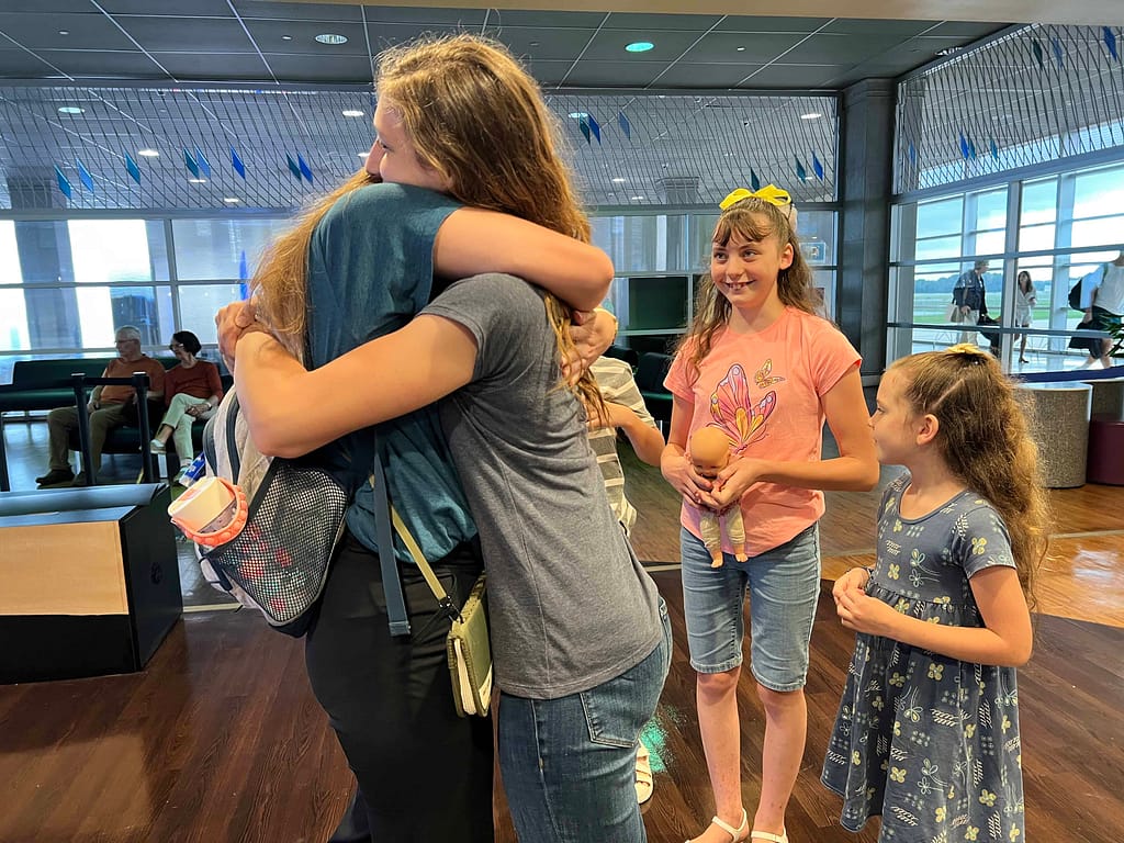hugging someone at the airport