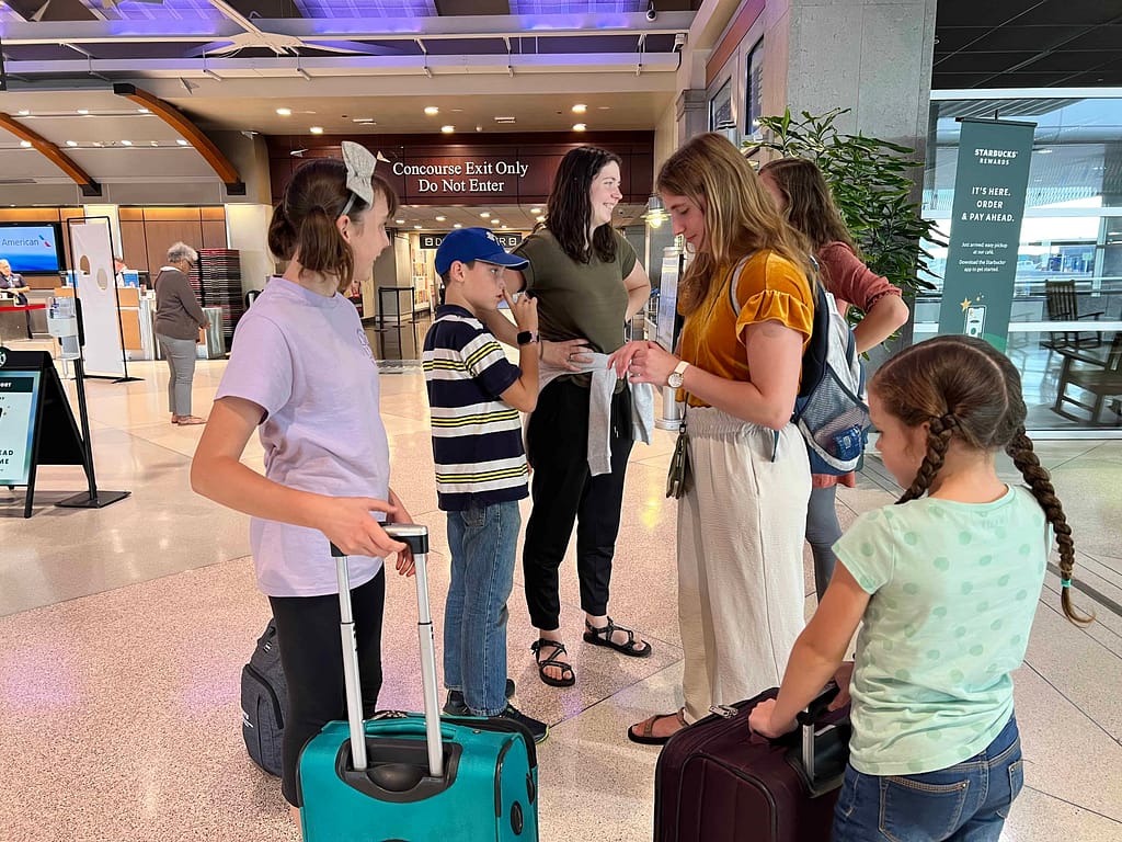 siblings hugging goodbye at the airport