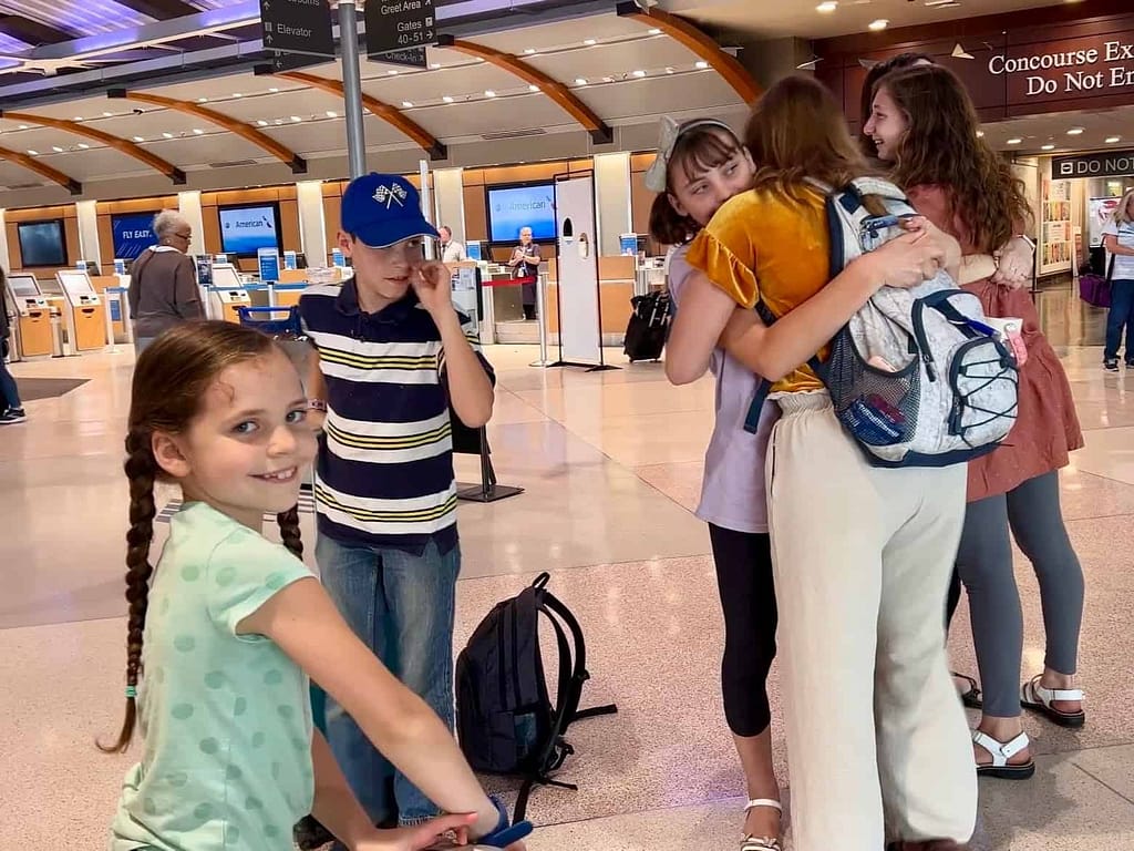 siblings saying goodbye at the airport
