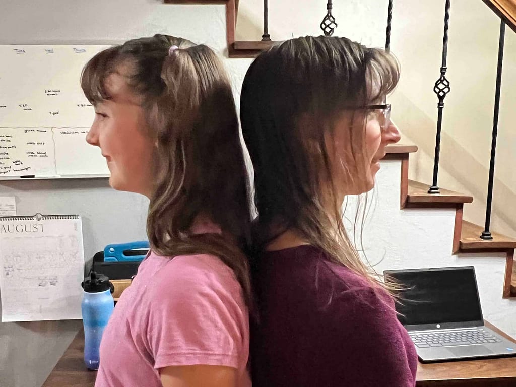 mom and daughter comparing heights