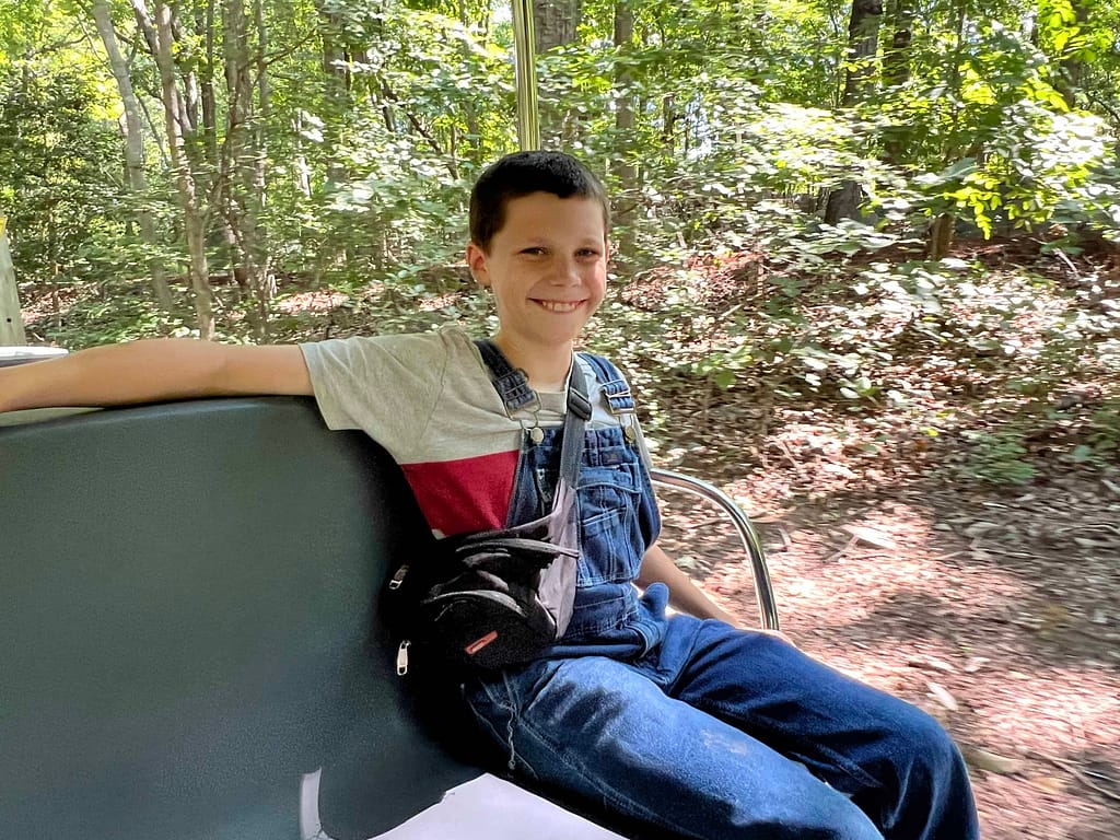 boy riding tram at zoo