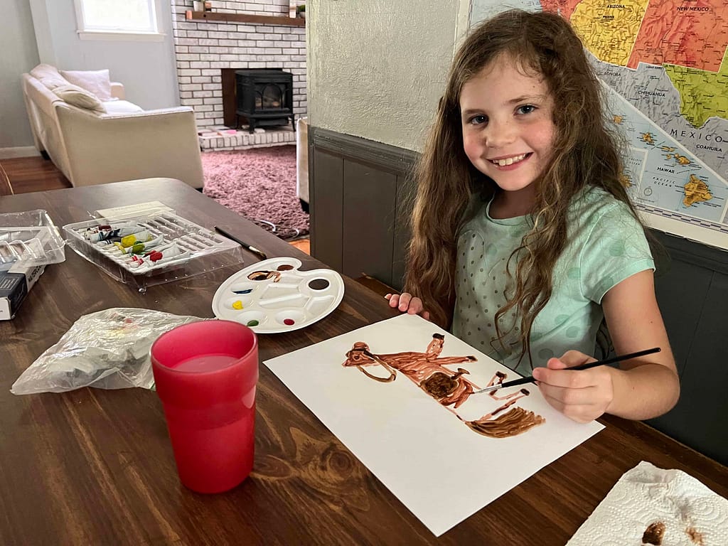 8 year old girl painting a picture of a horse